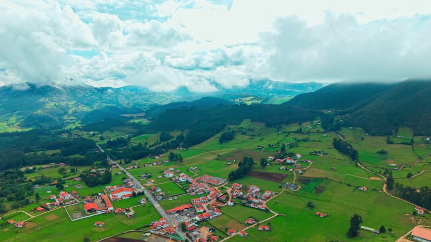 Aerial view establishing the mountains of the highlands of Colombia in Cundinamarca with clouds and a visual with mountains dense with green, on the way to the lagoon of Guatavita.
