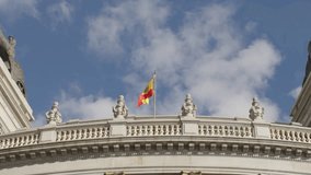 SLOW MOTION ZOOM OUT SHOT OF A SPANISH FLAG WAVING AT A BUILDING IN MADRID - Powered by Shutterstock - Get 15% off with code: PIKWIZARD15