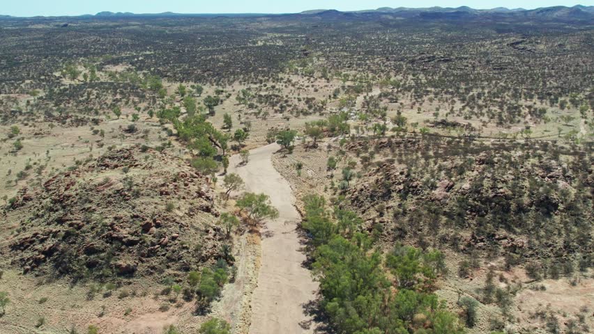 Aerial view of the dry Todd River upstream of the Telegraph Station, north of Alice Springs, Mparntwe, Northern Territory, Australia. August 2022.