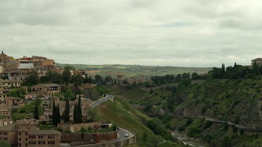 SLOW MOTION CLOSE UP PANNING SHOT OF TOLEDO CITY IN SPAIN AT A CLOUDY DAY