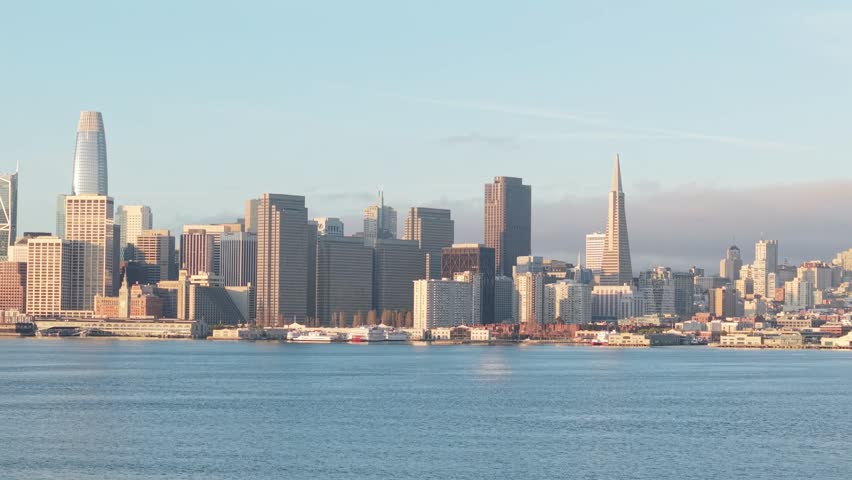 Morning fog lifts as the skyline emerges, revealing the full stretch of San Francisco’s eastern architectural spine.