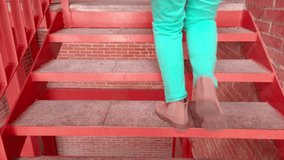 Person walking up concrete step, wearing turquoise pants and beige suede shoes - Powered by Shutterstock - Get 15% off with code: PIKWIZARD15