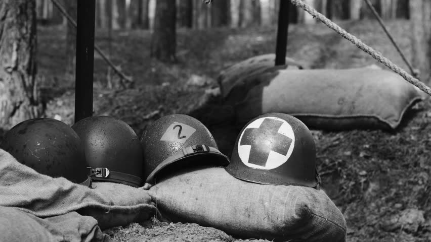 Historical Re-enactment Black And White Video. WWII American Metal Helmets Of United States Army Infantry Soldier At World War II. Helmets Near Camping Tent In Forest Camp.