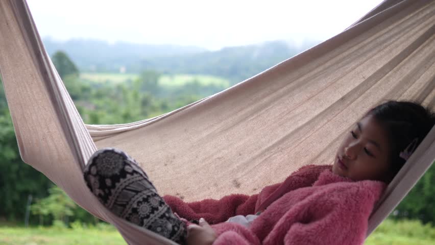 Asian Girl Sleeping on Hammock Outdoors in Peaceful Natural Environment