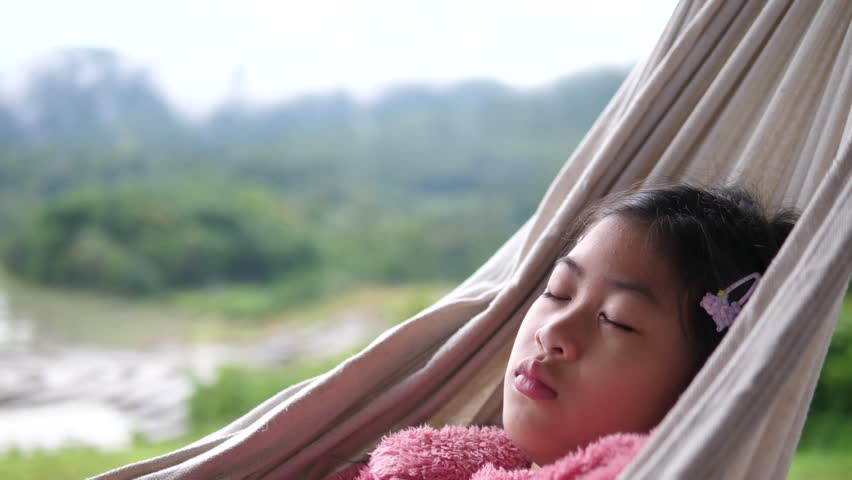 Asian Girl Sleeping on Hammock Outdoors in Peaceful Natural Environment