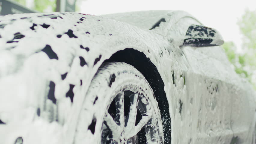 Car Covered in Thick Foam at Car Wash Station, Car Cleaning Process