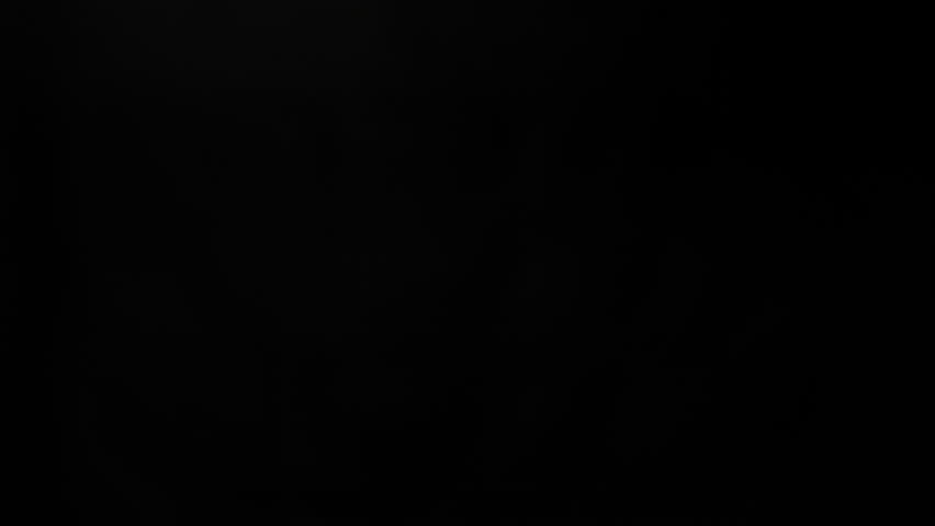 Golf Ball Flying and Rotating in Super Slow Motion on Black Background, 1000 fps.