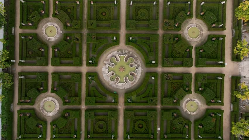 Aerial view over Jardim do Paço Episcopal in Castelo Branco, a Baroque gem with ornate lakes, statues, and manicured hedges, revealing a serene blend of history and nature in the heart of the city.