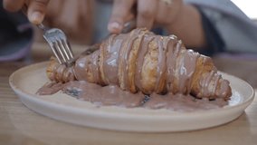 Person eating a chocolate croissant - Powered by Shutterstock - Get 15% off with code: PIKWIZARD15
