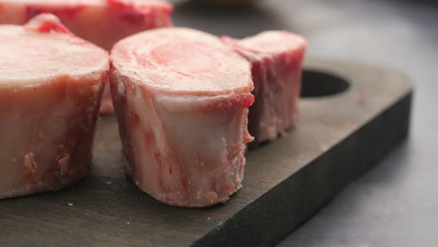Close-Up of Fresh Bone Marrow Slices on Dark Surface