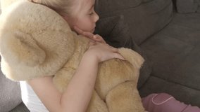 close-up teddy bear, child, young girl finds comfort in teddy bear, emotional support, trusting with innermost feelings and childhood dreams, child's bond with toy, childhood memories - Powered by Shutterstock - Get 15% off with code: PIKWIZARD15