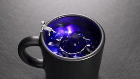 Miniature astronaut sliding into swirling cosmic vortex within ceramic black mug, symbolizing science fiction space exploration journey through gravitational singularity. 3D Illustration - Powered by Shutterstock - Get 15% off with code: PIKWIZARD15
