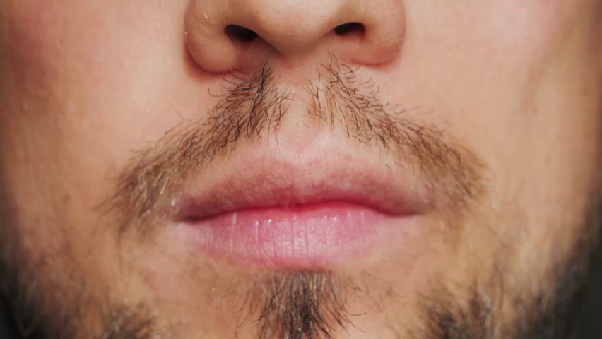Man putting on a mouthguard, close-up. Dental trainer for adults for the treatment of bruxism. High quality 4k footage