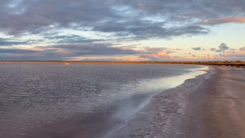 Salt lake with water flowing through minerals during sunset in Western Australia