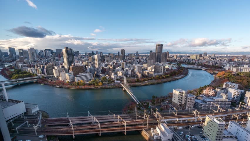 Osaka Japan time lapse city skyline day to night at Okawa River and Kawasaki Bridge