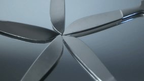 Five Scalpels fanned out rotating on mirror
