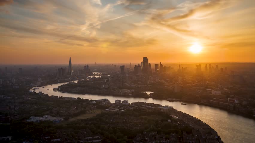 Summer sunset time lapse view of the skyline of London, United Kingdom, with colorful clouds and red sunlight