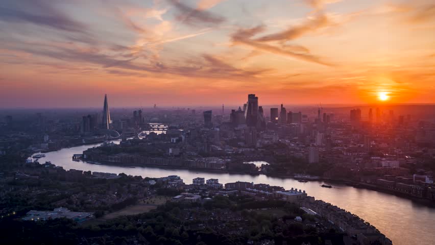 Summer sunset time lapse view of the skyline of London, United Kingdom, with colorful clouds and red sunlight