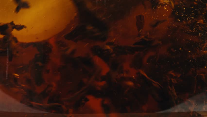 Ginger tea, freshly brewed black organic herbal tea with ginger, mint and lemon in a glass teapot, medication healthy.