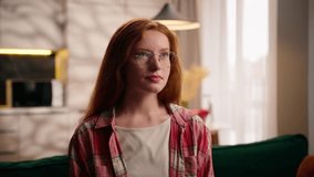 Caucasian redhead girl teen female woman at home living room on sofa thinking concentrated doubt think pondering create decision looking idea clever wearing glasses student at apartment thoughtful - Powered by Shutterstock - Get 15% off with code: PIKWIZARD15