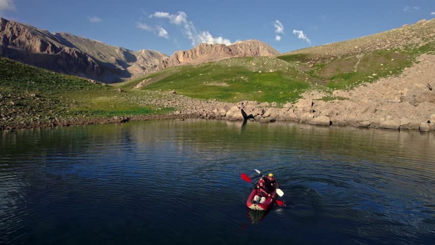 “Serene Kayaking Experience in Alpine Lake With Ice Patches”