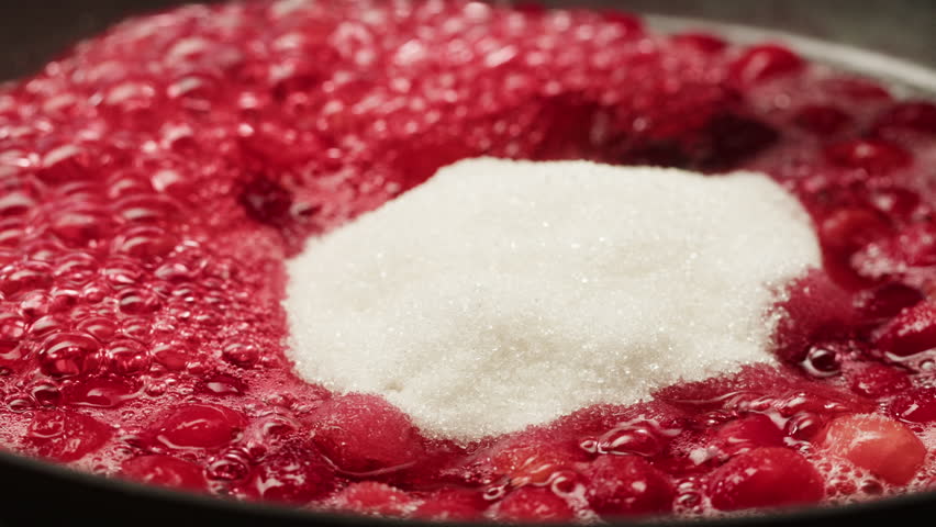 Frozen cranberries cooking for tea or jam, Background Close up of cranberry berries in on the kitchen, chef making dessert healthy pie.