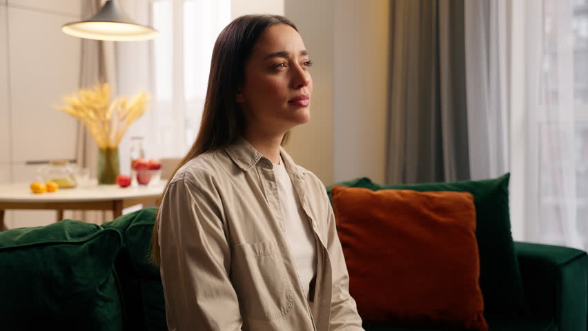 Portrait sleepy tired exhausted yawning Caucasian woman girl female lady feeling fatigue sitting at couch problem health napping yawn at home in living room stretching hands relaxation lazy boring