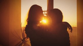 Dark silhouette two person hugging embracing each other in sun rays light warm flare. Concept of love family. Cozy Room window. Close-up couple adult woman daughter hugs old mother elderly senior lady - Powered by Shutterstock - Get 15% off with code: PIKWIZARD15