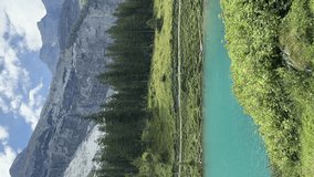 Oeschinensee lake panning revealing surrounding mountains and forest.Vertical video - Powered by Shutterstock - Get 15% off with code: PIKWIZARD15