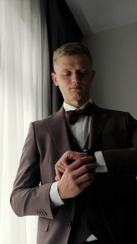 Groom checking the time before the wedding ceremony, A striking image of the groom checking his watch as he prepares for the wedding ceremony