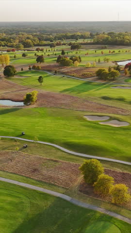 Aerial view of a lush golf course with water features, A scenic aerial view of a green golf course during daylight,
