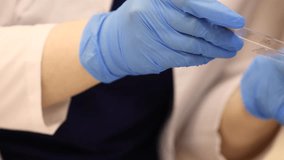 Graduate researchers in rubber gloves examining a sample slide with biomaterial for analysis under an electron microscope in a laboratory. Modern science and biomedical research scene. - Powered by Shutterstock - Get 15% off with code: PIKWIZARD15