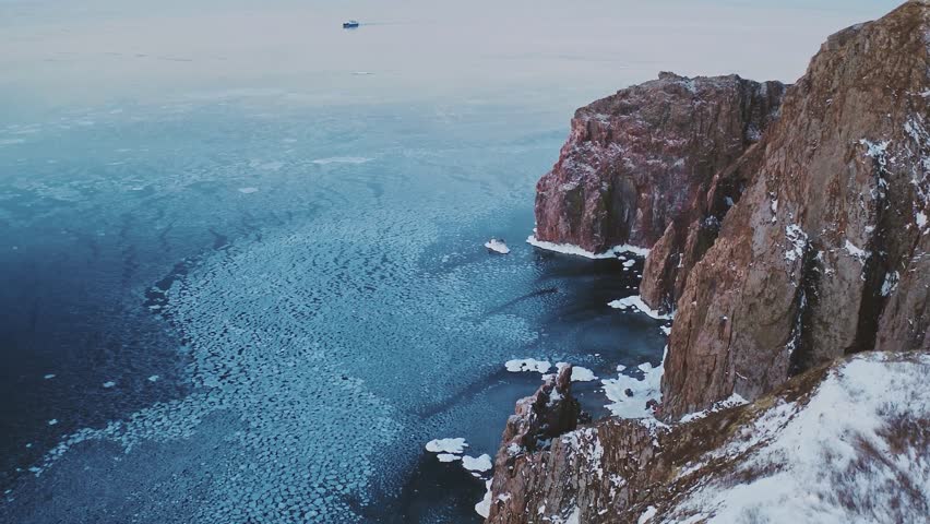 Aerial Drone Footage of Icy Ocean Bank with Hill – Frozen Coastal Landscape
This high-resolution aerial footage captures a dramatic and breathtaking view of an icy ocean bank bordered by a rugged hill