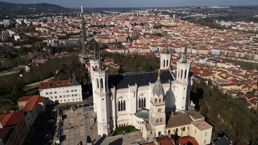 Notre-Dame de Fourviere Basilica in Lyon, France, with clear blue sky, iconic landmark and religious architecture, panoramic view from below