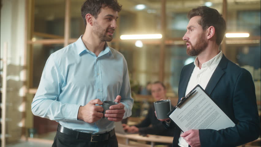Caucasian men conversation friendly talking in office break coffee drinking together business guys male co-workers businessmen colleagues entrepreneurs friends teammates meeting consulting at company - Powered by Shutterstock - Get 15% off with code: PIKWIZARD15