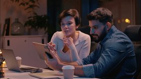 Caucasian woman Indian man multiracial business colleagues businesswoman businessman co-workers designers working laptop digital tablet using devices in night office diverse girl guy discuss website - Powered by Shutterstock - Get 15% off with code: PIKWIZARD15