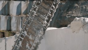 Industrial wire saw cutting through marble block, on marble quarry landscape. Mining concept. - Powered by Shutterstock - Get 15% off with code: PIKWIZARD15