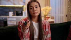 Woman watching television at home night insomnia TV show film movie watch alone on couch eating popcorn snack relax rest in evening apartment female Caucasian girl tenant homeowner switch channel - Powered by Shutterstock - Get 15% off with code: PIKWIZARD15