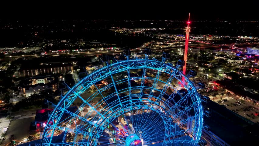 Ferris Wheel At Orlando In Florida United States. Illuminated Amusement Park. Universal Orlando Scene. City Night Scenery. Orlando United States. Ferris Wheel At Orlando In Florida United States.
