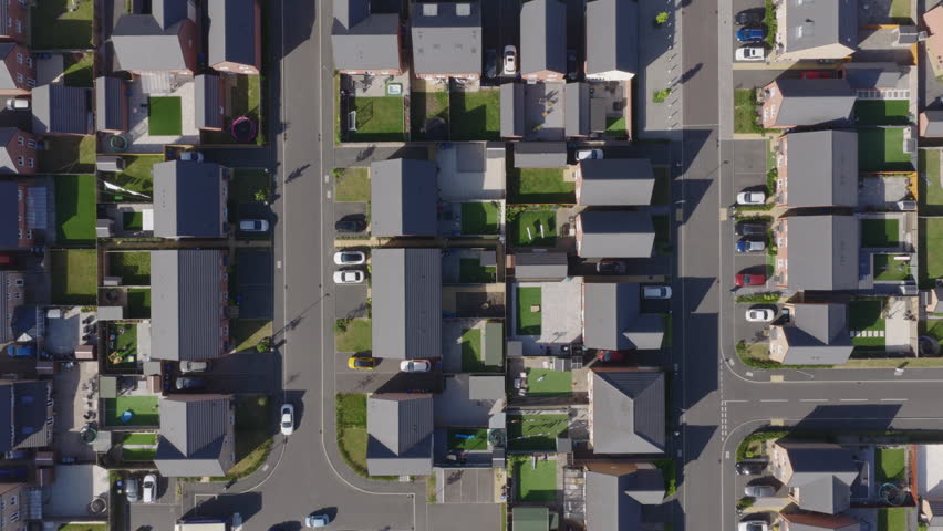 Top down aerial view of new build suburban houses in the United Kingdom. Housing market and suburban lifestyle concept.
