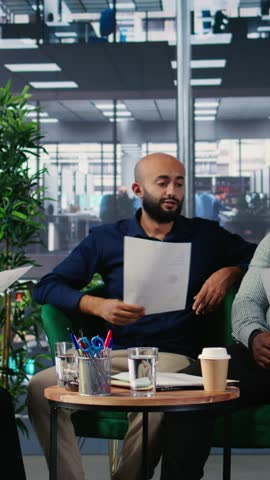 Vertical Video Diverse business professionals using analysis tools to extract details and insights for career growth and a collaboration for long term success story. Strong work ethic in office