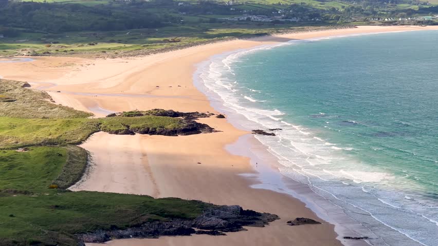 Aerial View of Ballymastocker Beach with Walkers and Cloud Shadows