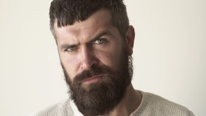 Serious bearded man closeup. Confident male model portrait. Handsome guy. Hipster man with a sharp profile. Thoughtful male face closeup. Man with a serious expression. Confident man.