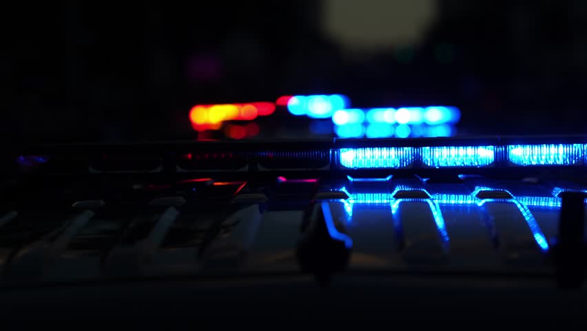 Police car lights flashing. Crime scene at night. Patrol vehicle outdoors. Emergency lights glowing. Flashing police siren. Police car vehicle. Law enforcement. City night patrol. Police arrest.