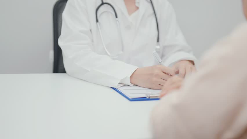 Doctor explaining diagnosis and treatment plan to elderly patient during hospital appointment. Senior patient talking doctor to disease. medical consulting, geriatric care, healthcare concept 