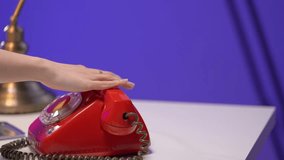 A hand reaches for a red rotary phone on a retro desk, beside a yellow typewriter and classic lamp. The nostalgic atmosphere blends vintage tools with colorful lighting and tactile office details - Powered by Shutterstock - Get 15% off with code: PIKWIZARD15