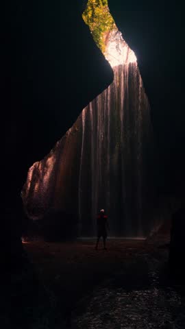 Travel people enjoy wonderful view Tukad Cepung Waterfall Bali famous landmark and popular travel destination Bali, Indonesia 4K