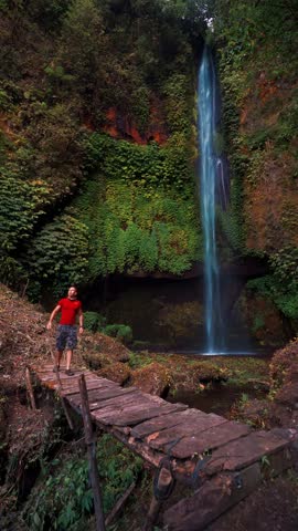 Travel people enjoy beautiful view Bali waterfall Pucak Manik one of the most beautiful waterfalls Bali located north of Lake Buyan Bali, Indonesia 4K