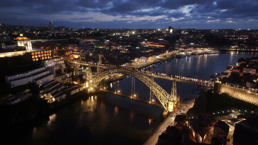 Night Dom Luis I Bridge At Porto In District Of Porto Portugal. City At Night Scene. Illuminated Bridge Landscape. Dom Luis I Bridge At District Of Porto Portugal. Railroad Transport.
