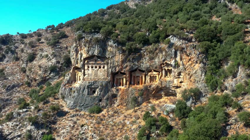 Ancient Rock-Cut Tombs in Mountainside Landscape